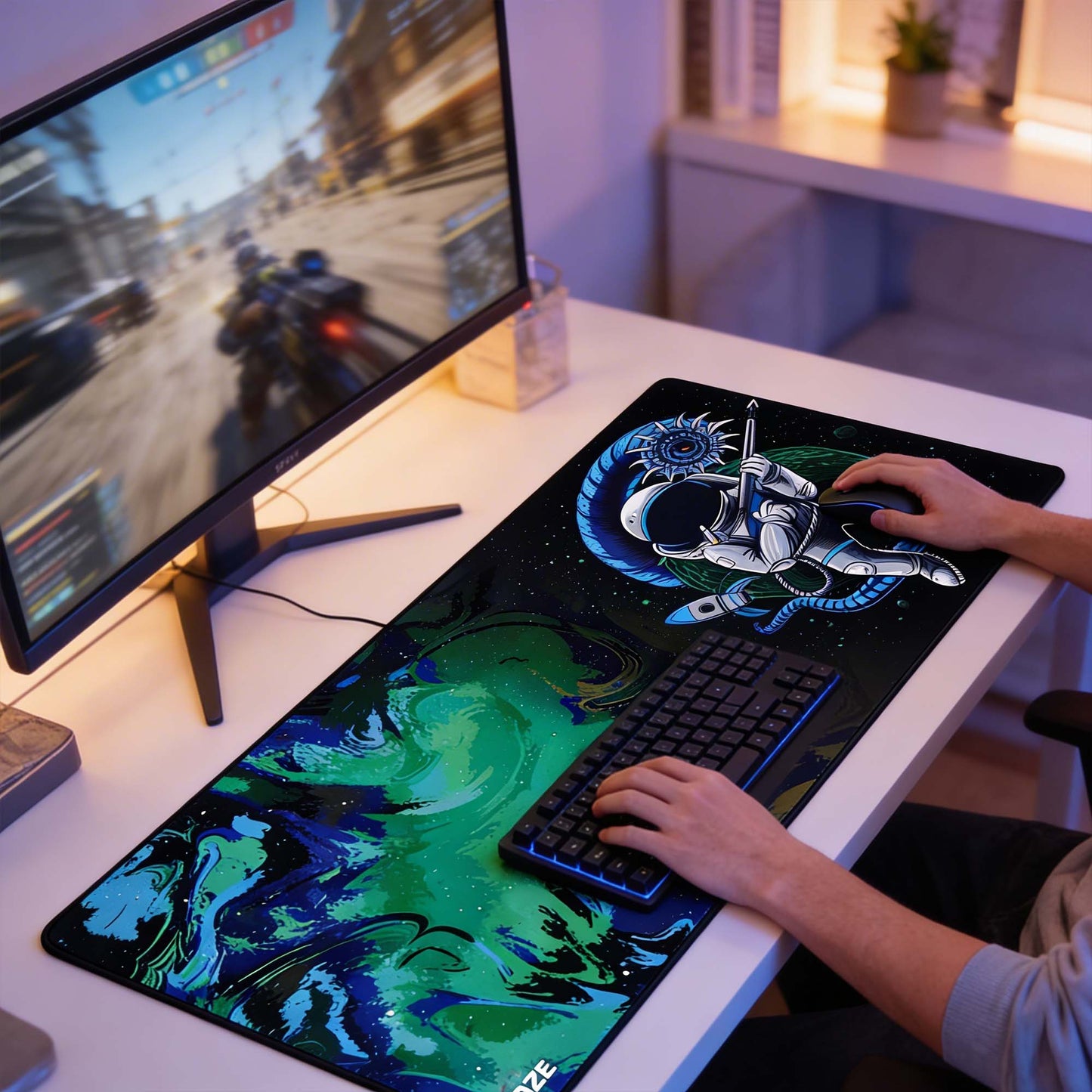Person playing a game on a computer with a large mouse pad and keyboard on a desk.